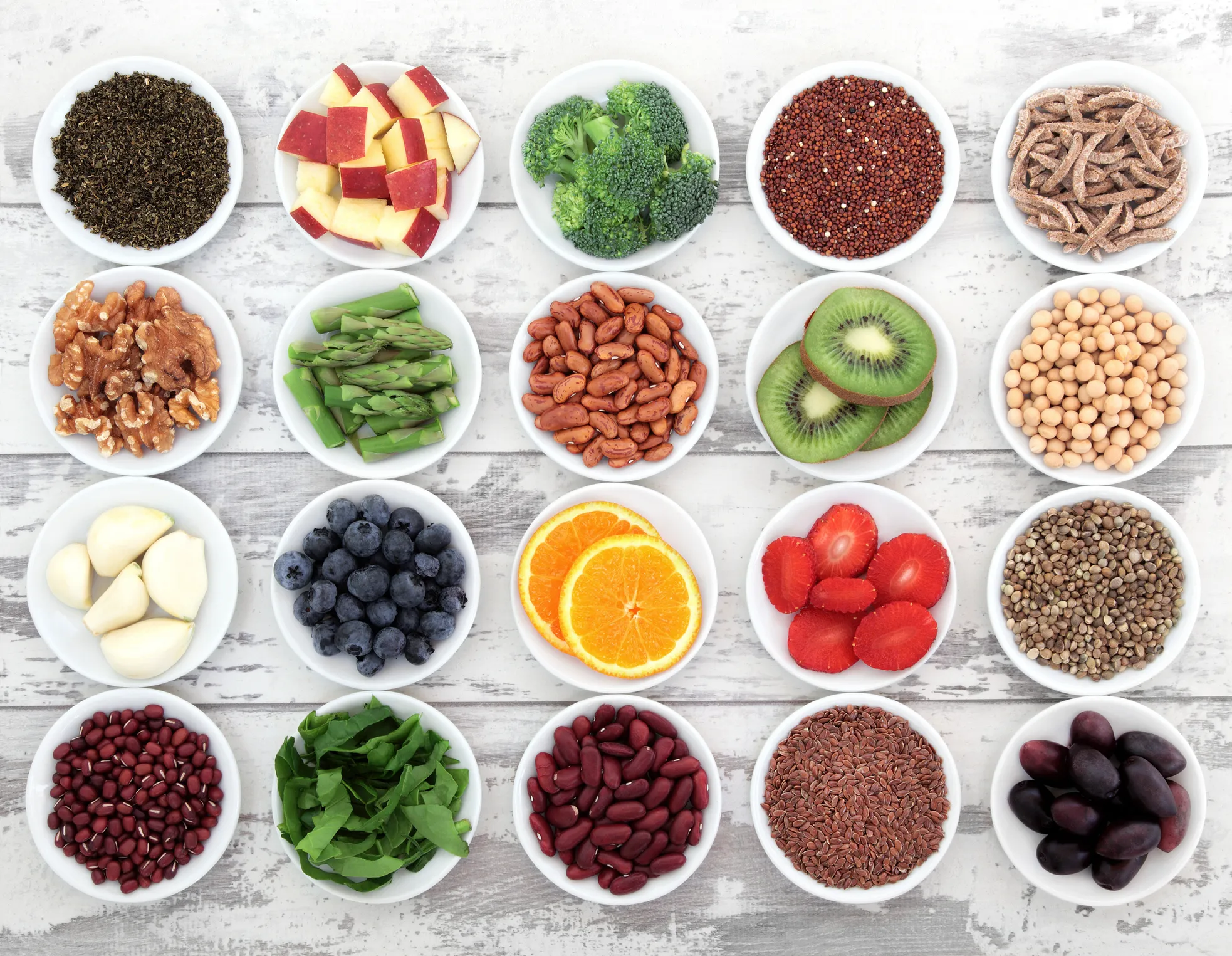 Variety of whole foods representing different macronutrient sources including nuts, grains, and vegetables